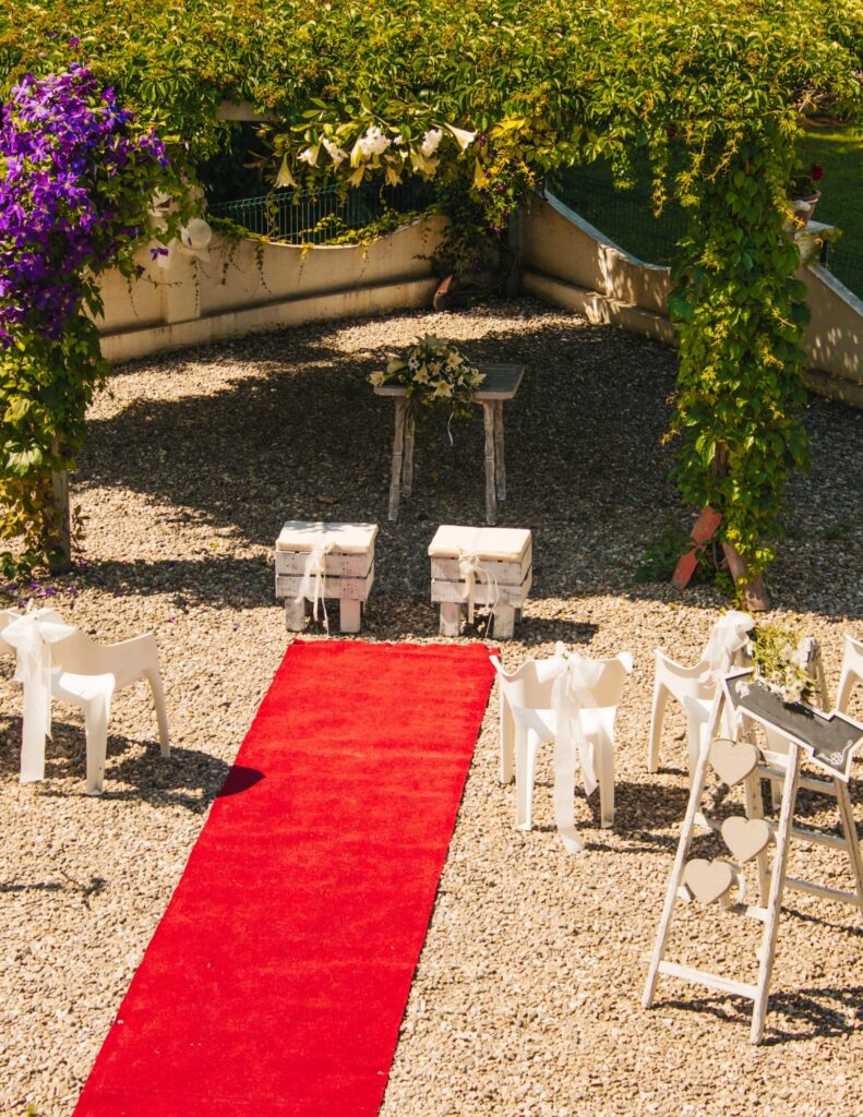 outdoor wedding venue with a red carpet on gravel