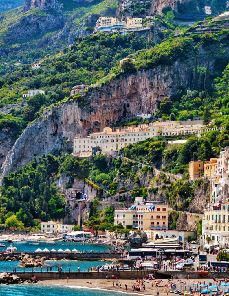 a portrait photo of Italy's Amalfi Coast with beachgoers having a lovely holiday
