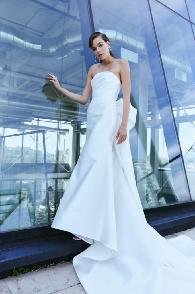 Remi is a brand new Rivini from the Fall 2024 collection heading to The Wedding Shoppe. It has a modern ruched neckline with a statement bow train