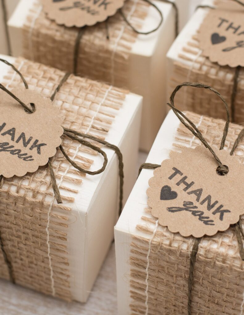 several thank you gifts as wedding favors tied with twine and burlap for sustainability