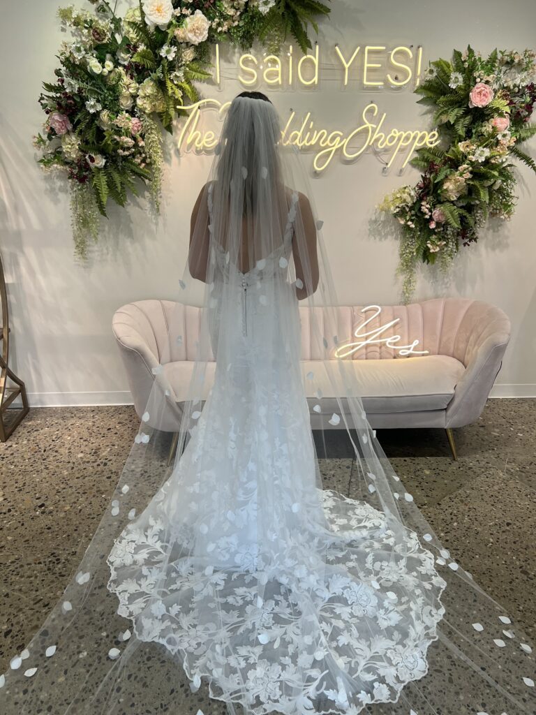 a bride wearing a wedding veil with flower petals