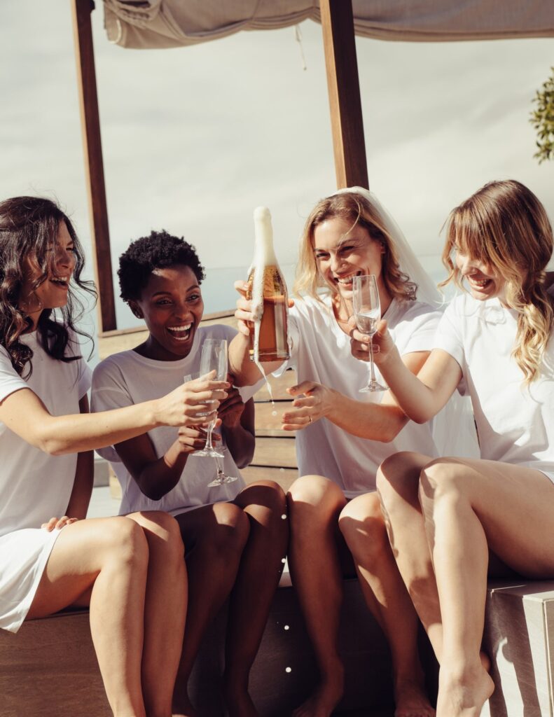 a group of friends sharing champagne at a rooftop bachelorette party