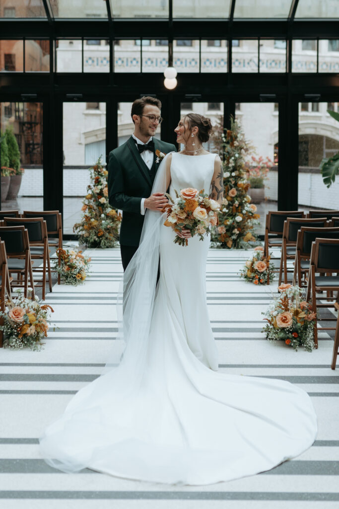 bride and groom posing at their wedding venue: The Shinola Hotel
