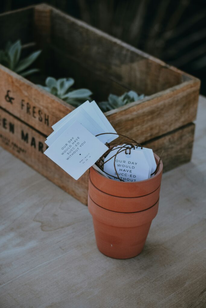 seed packets in terra cotta pots as a summer wedding favor