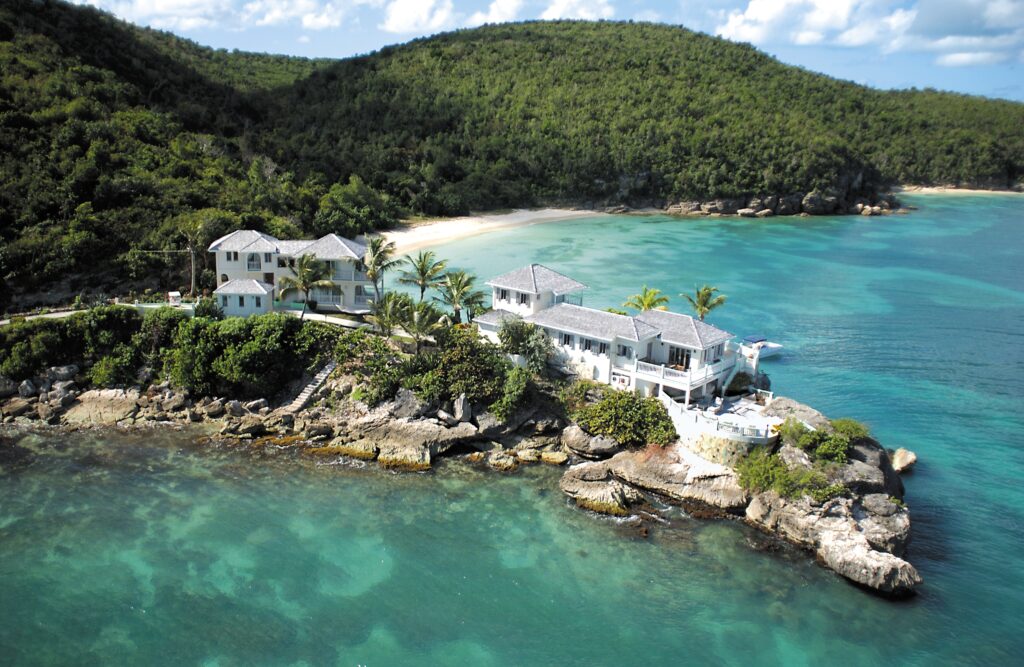 an aerial view of 2 houses on the water in Antigua