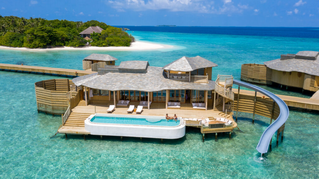 a honeymoon retreat with a slide from the second floor directly into the water