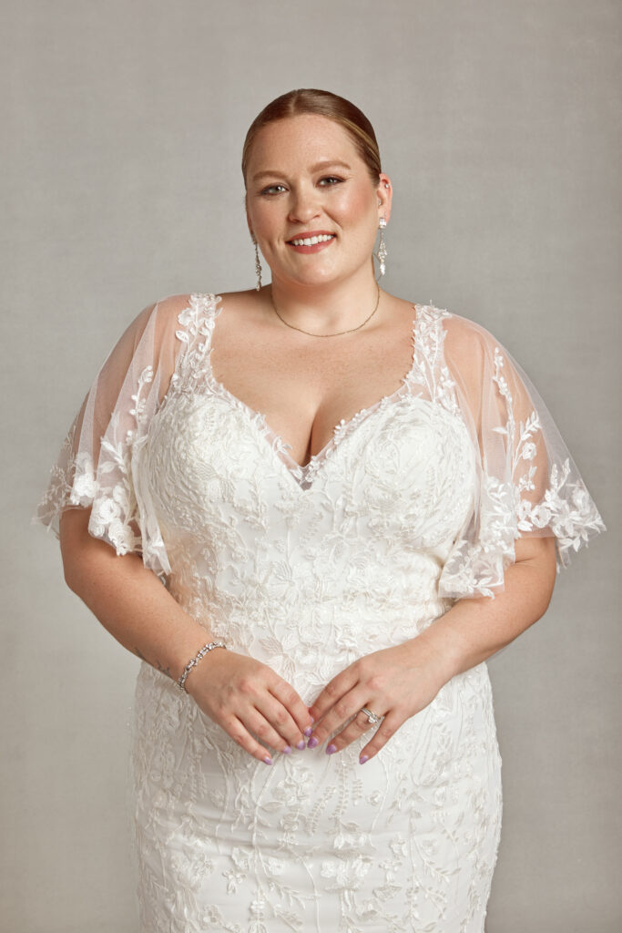 woman wearing a classic wedding gown with lace sleeves at The Wedding Shoppe in Detroit