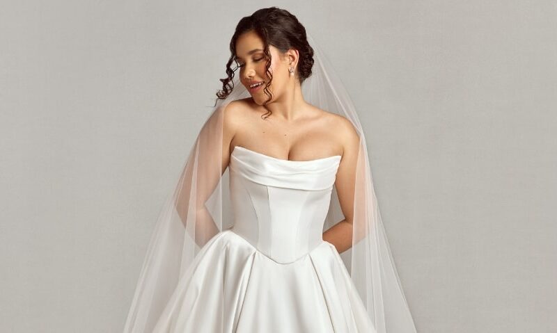 Woman wearing a simple, elegant wedding ballgown with a long veil