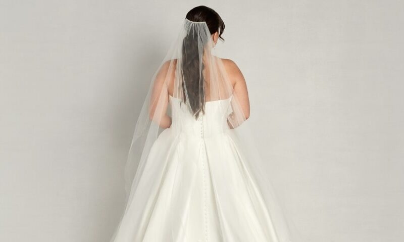 A gorgeous traditional lace cathedral veil worn by a woman at The Wedding Shoppe in Detroit