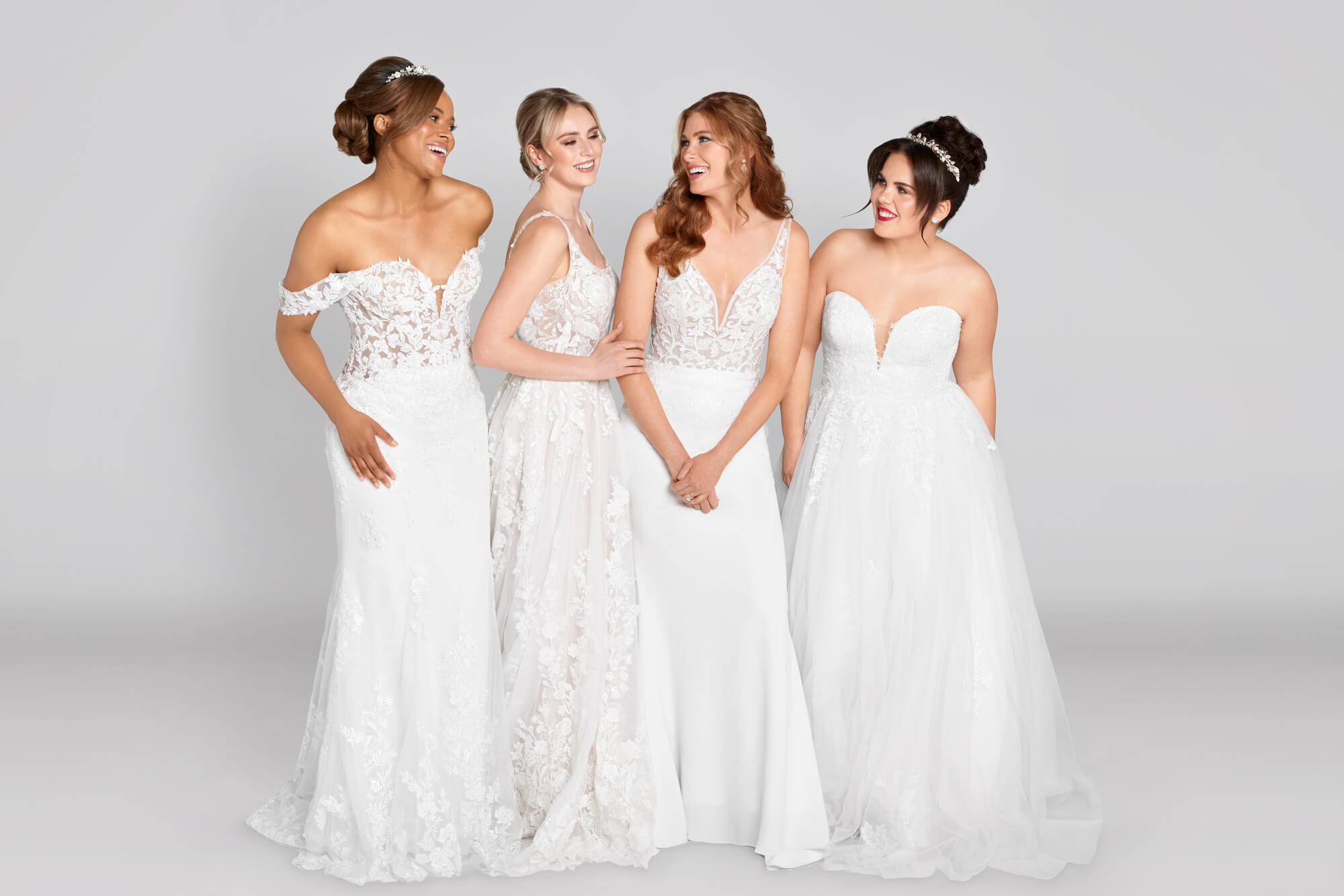 4 woman modeling bridal dresses