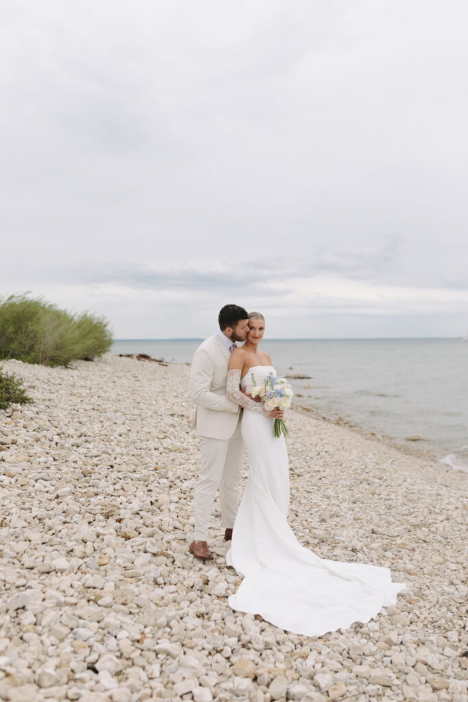 husband and wife sharing a kiss on Mackinac Island in Michigan