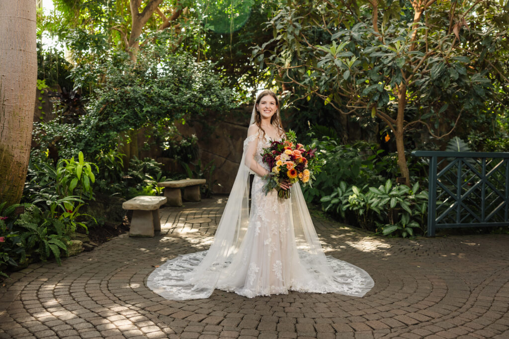 A bride standing at Frederick Meijer Gardens for her wedding photography