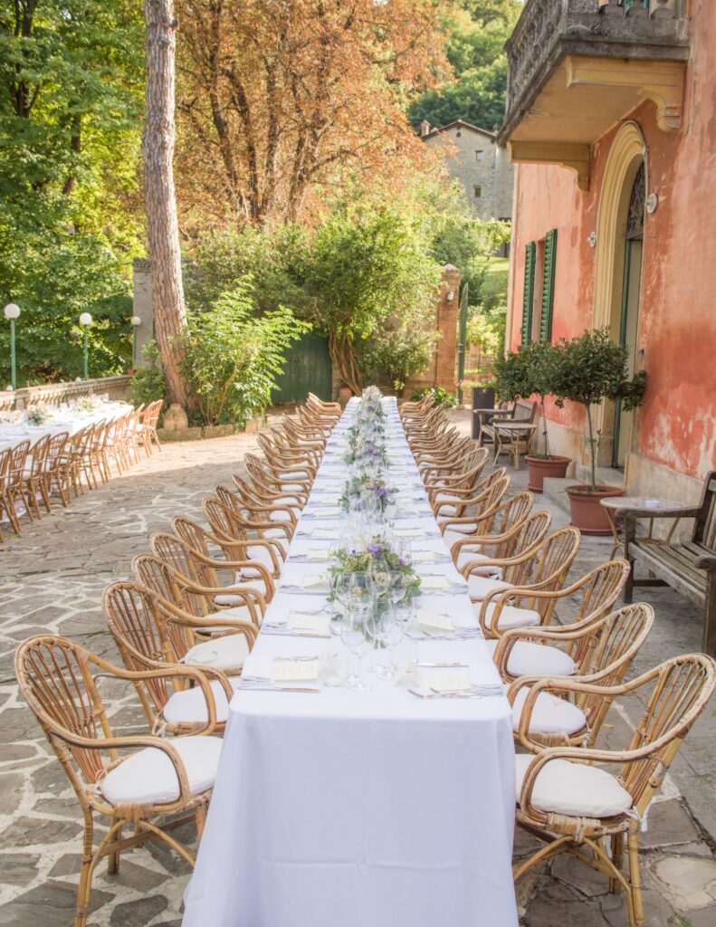 A european wedding location with long tables set up outside the venue