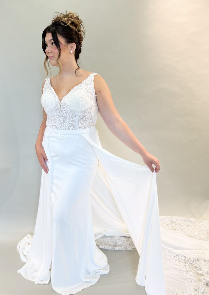 Bride wearing Baldwin, a chiffon sheath gown with a lace bodice and a chiffon/lace overskirt