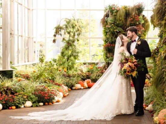 Happy married couple posing for wedding photos at the Frederick Meijer Gardens in Michigan