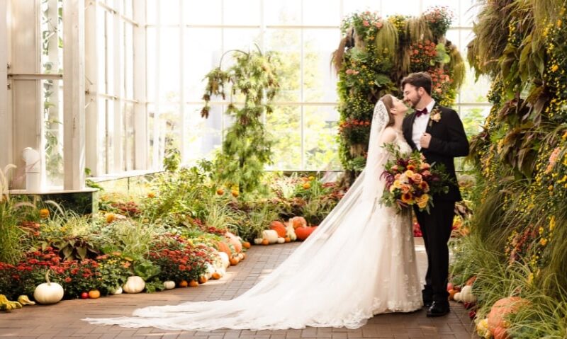 Happy married couple posing for wedding photos at the Frederick Meijer Gardens in Michigan