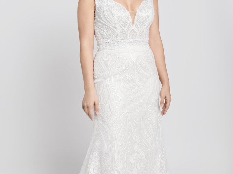 Bride to be wearing a boho lace wedding dress with a deep v cut neckline and geometric style lace.