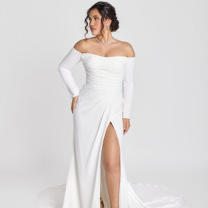 Gorgeous bride wearing a form fitting, off the shoulder, long sleeve wedding dress with a slit in one thigh.