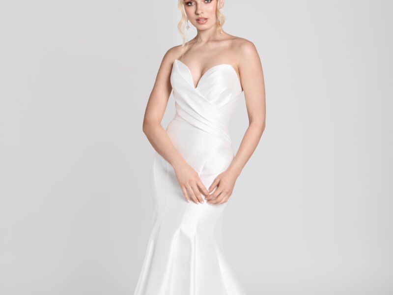 Bride to be wearing a simple fit and flare wedding dress with a deep sweetheart neckline and crossover folding on bodice.