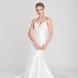 Bride to be wearing a simple fit and flare wedding dress with a deep sweetheart neckline and crossover folding on bodice.