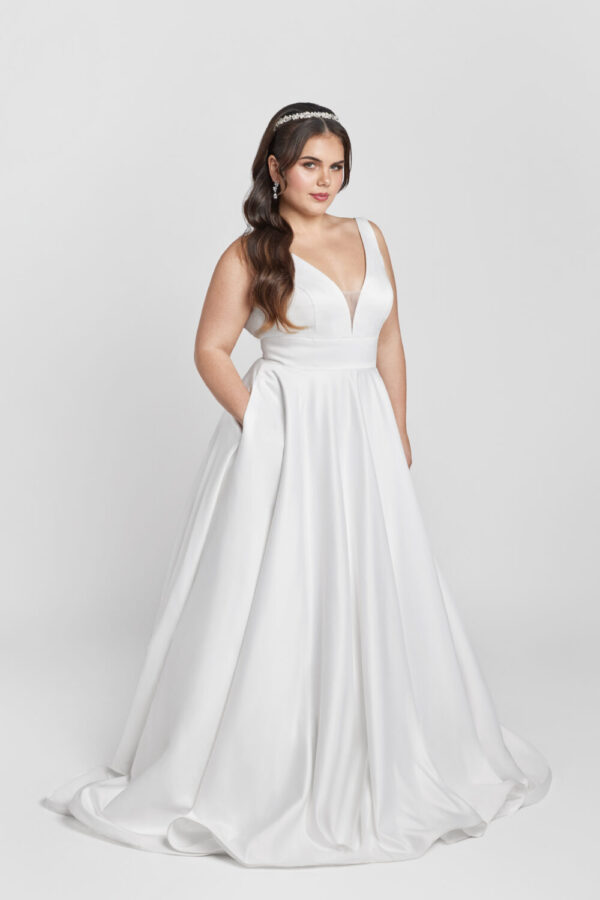 Plus size bride wearing a classic, timeless wedding dress with pockets.