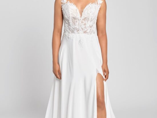 Model wearing a floral lace wedding dress with a see through lace bodice and a simple skirt spread around her and a slit up the thigh.