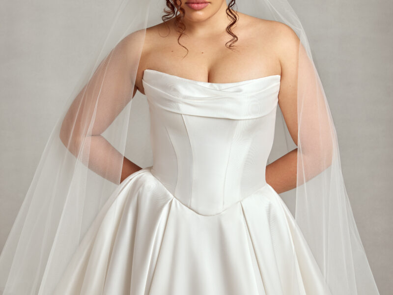 Traditional style bride wearing a corset wedding dress with a basque waistline and full skirt.