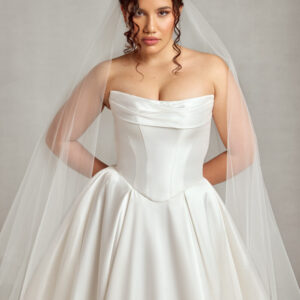 Traditional style bride wearing a corset wedding dress with a basque waistline and full skirt.