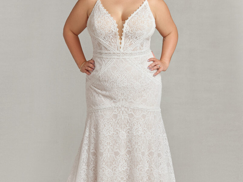 Classy bride to be modeling a vintage style wedding dress with spaghetti straps and lace overlay.