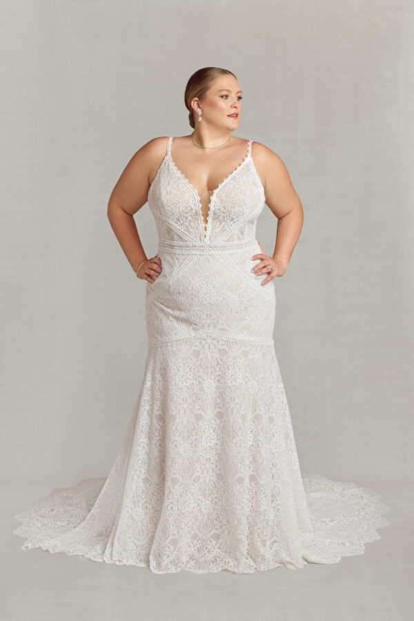 Classy bride to be modeling a vintage style wedding dress with spaghetti straps and lace overlay.