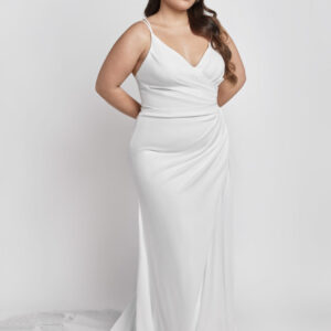 A classic style wedding dress with spaghetti straps and the fabric gathered at one hip.