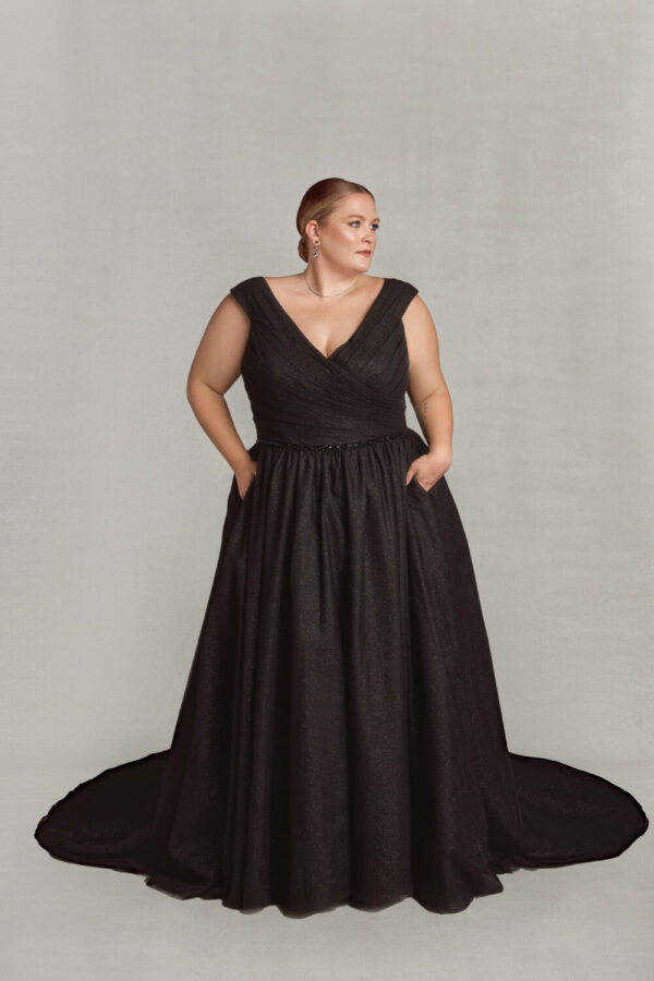 Classic style wedding dress with cap sleeves and v cut neckline. There are subtle black sparkles throughout the gothic wedding dress.