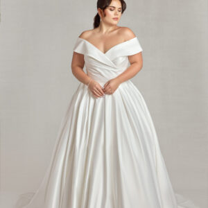 Traditional plus size bride modeling an off the shoulder sleeve wedding dress.