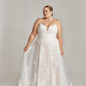 Fairytale wedding dress with floral lace bodice and layered, tulle skirt and floral decals throughout.