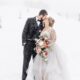 Snowy wedding scene with couple embracing, snowflakes gently falling around them.