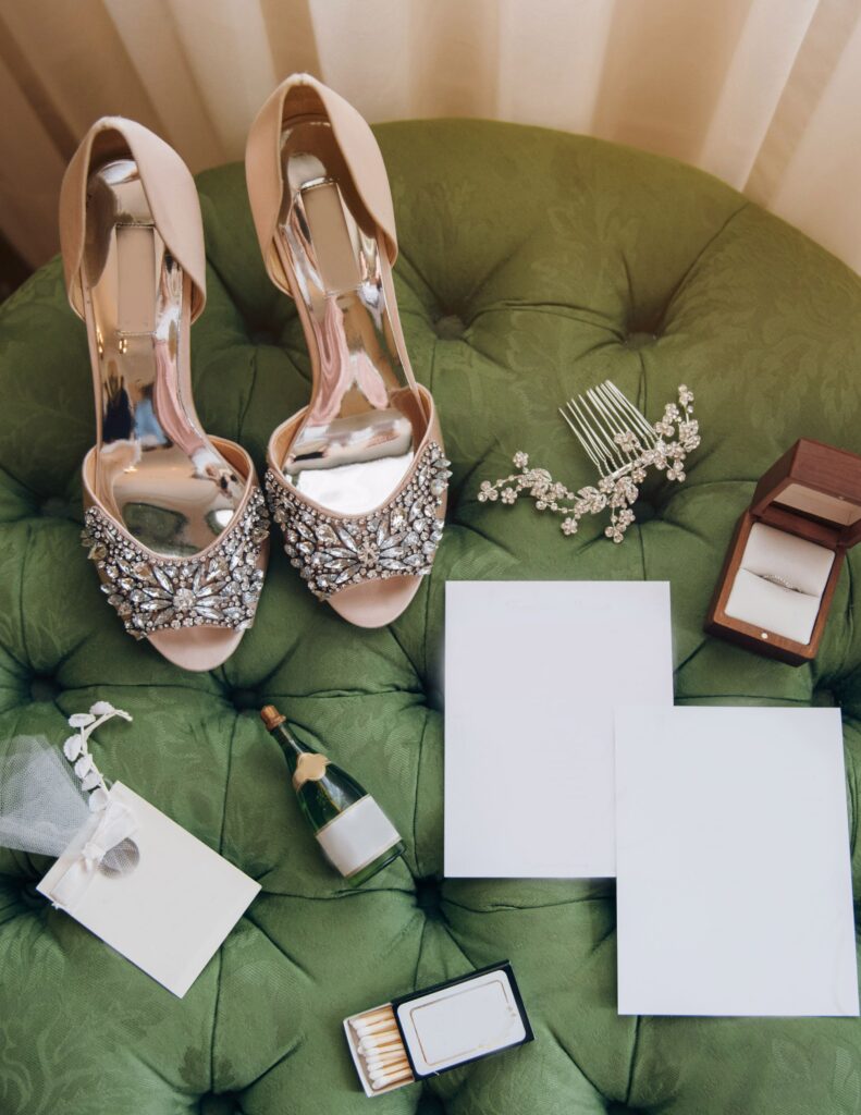 Wedding accessories elegantly arranged on a green velvet chair.