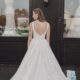 A back view of a floral lace ballgown wedding dress with a dramatic train, delicate detailing, and a classic open-back design.