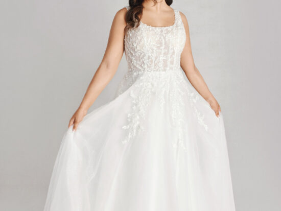 A bride in a white fitted lace floral dress.