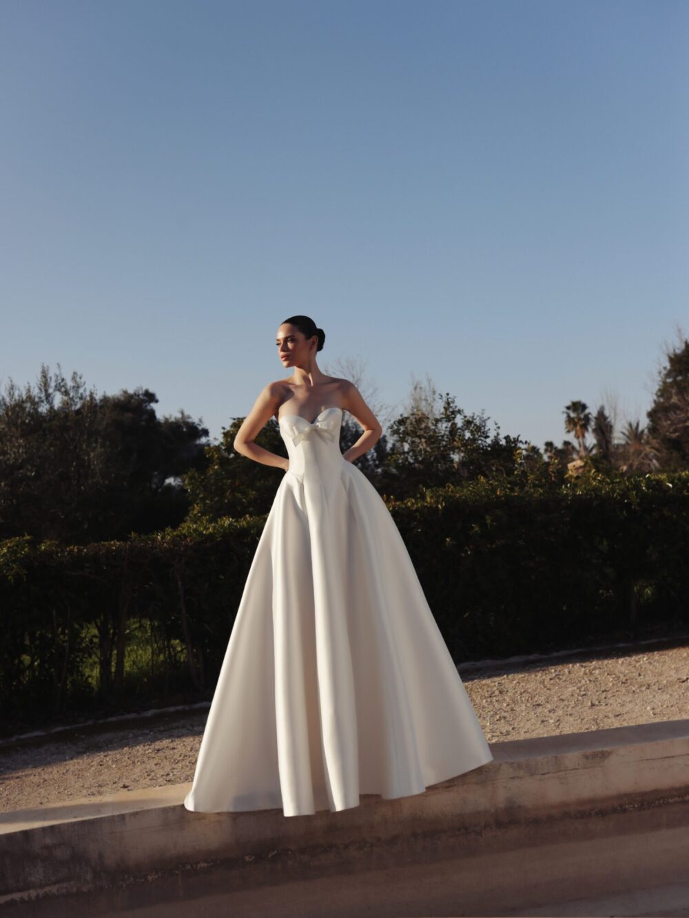 An A-line satin dress with a sweetheart neckline and a minimalist bow on the bust.