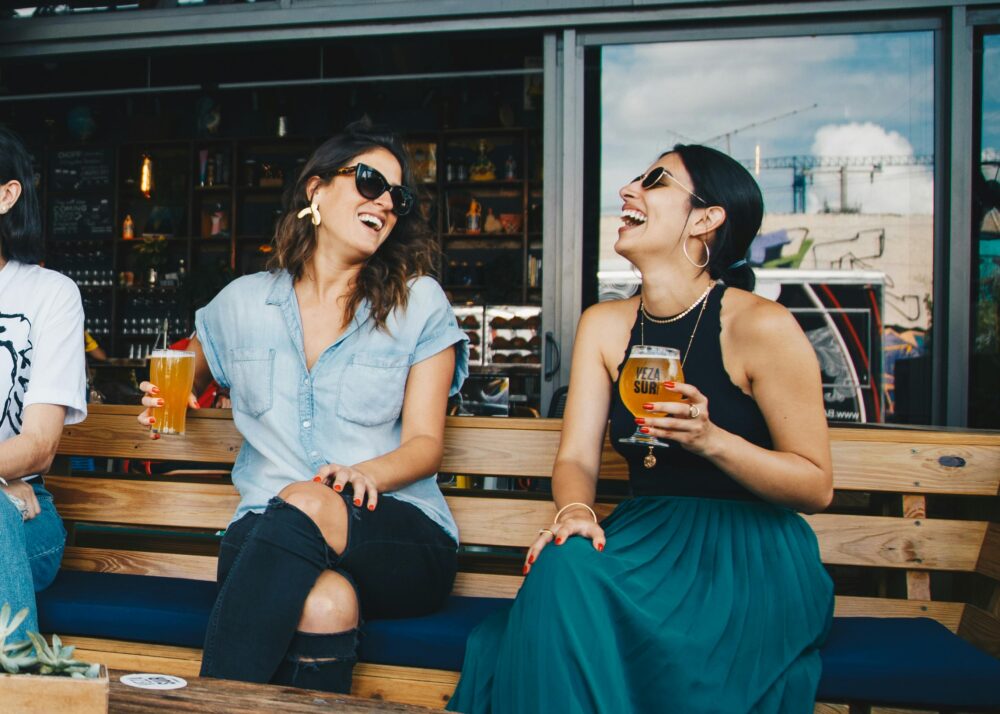 friends drinking beer at The Wedding Shoppe bridal bar crawl.