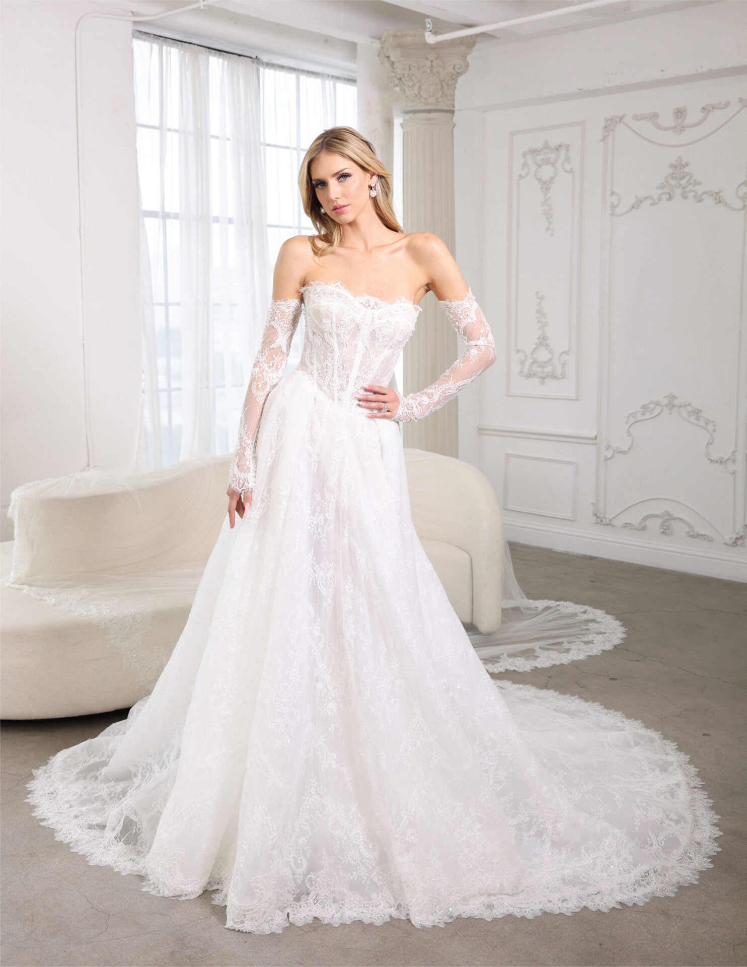 Bride in a romantic off-the-shoulder lace gown with a full skirt and sweeping train.