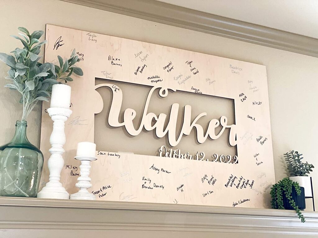 A wooden sign with the family name “Walker,” surrounded by handwritten messages, sits on a shelf with candles and a plant.