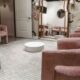 Cozy bridal fitting lounge with plush pink chairs, full-length mirrors, and a round white coffee table.