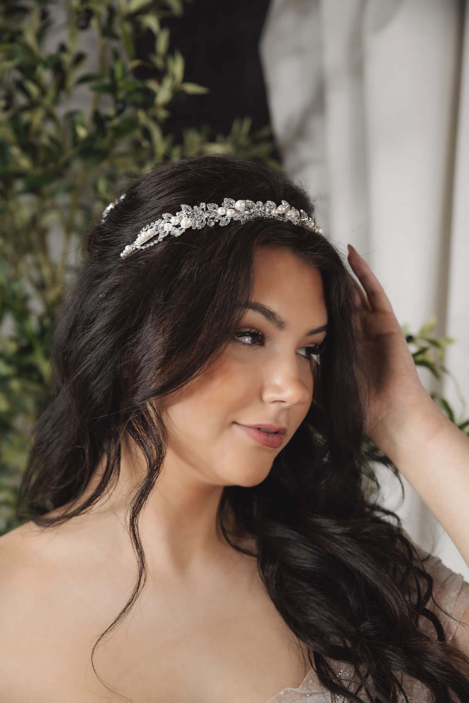A close-up portrait shows a bride with long dark hair wearing a sparkling pearl and crystal headpiece.