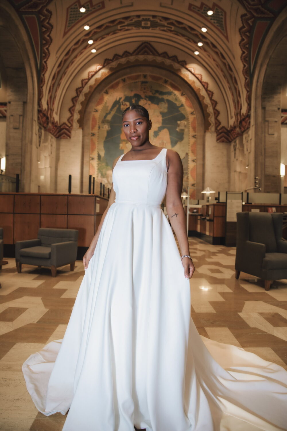Plus-size bride in a white wedding gown posing inside an ornate church.