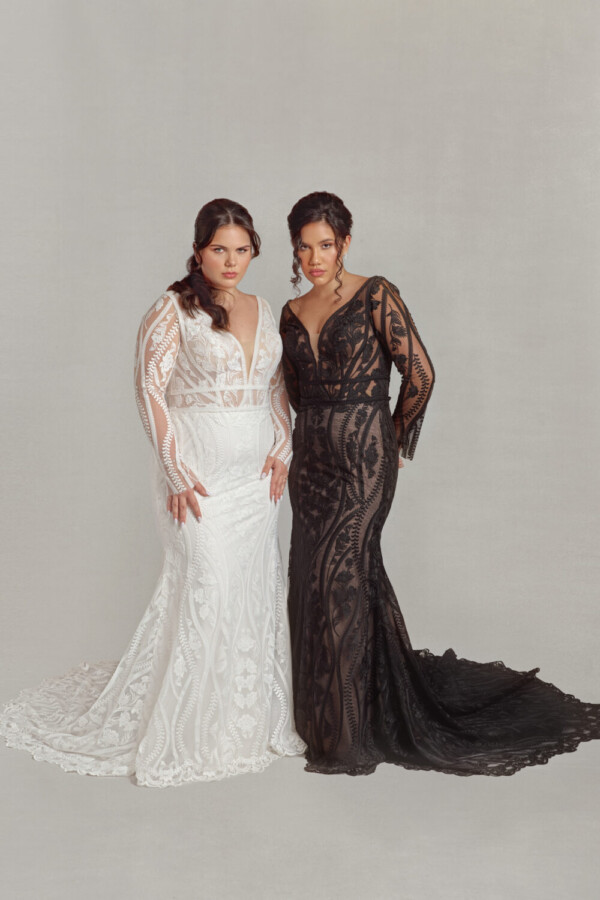 Two models wearing the Ashrina, modest lace wedding dresses. The model on the left is wearing a white version and the one on the right is wearing the black wedding dress version.