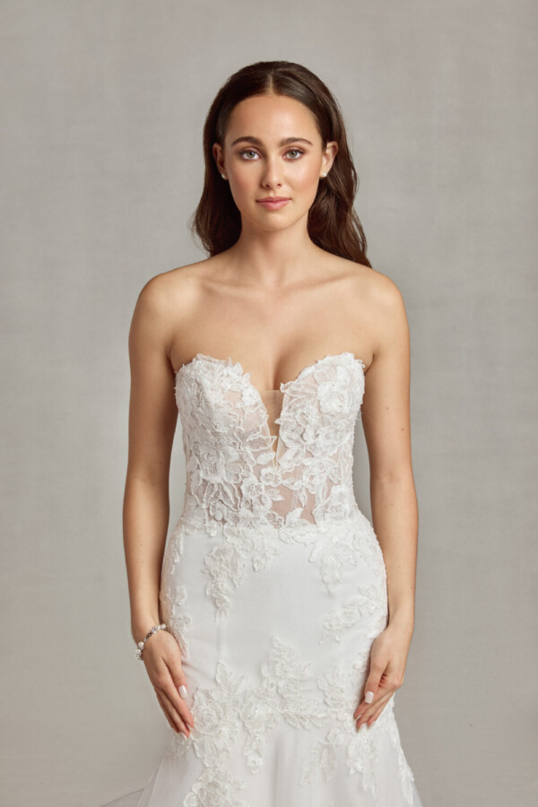 Sleeveless, sweetheard neckline wedding dress with floral decals on the bodice and onto the skirt.