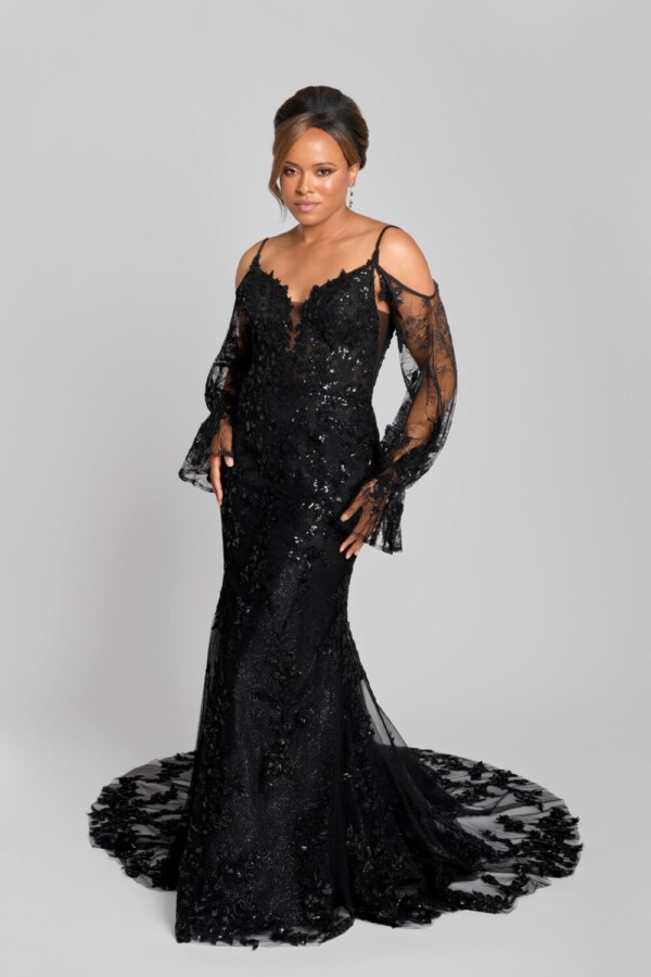 Gothic wedding dress being worn by a confident bride to be. The black wedding dress has long lace sleeves and black, beading on the bodice.