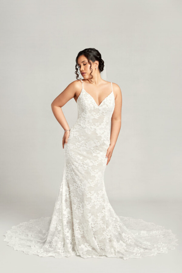 Traditional boho lace wedding dress with spaghetti straps and floral lace overlay.