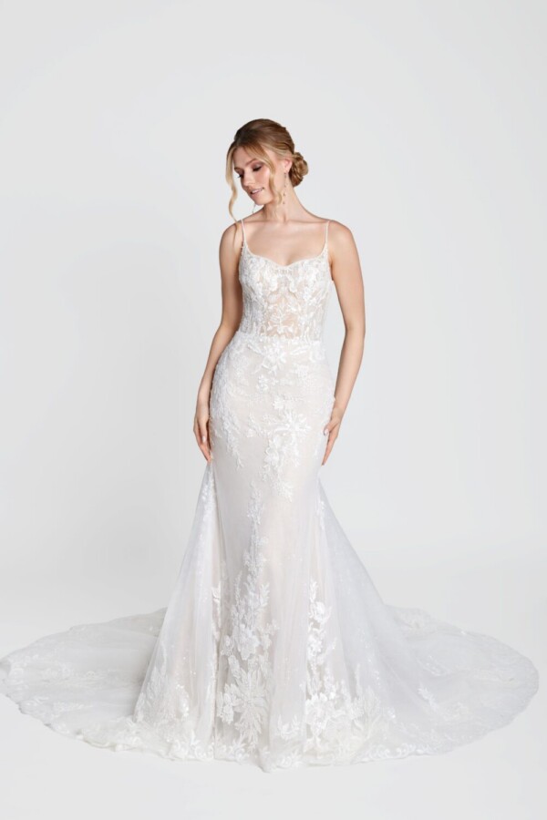 Captivating young bride to be wearing her boho lace wedding dress with spaghetti straps and floral details on the bodice.